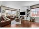 Inviting living room featuring a cozy fireplace, custom built-ins, and a comfortable sectional sofa at 14110 Pastel Ln, Parker, CO 80134