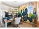 Bright and modern home office featuring a unique accent wall, stylish desk, and ample natural light at 14110 Pastel Ln, Parker, CO 80134