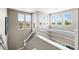 Bright staircase area featuring large windows with neighborhood views and modern white railing and stainless steel accents at 14110 Pastel Ln, Parker, CO 80134
