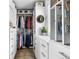 Walk-in closet with custom shelving and closet rod system, drawers, and natural light at 14110 Pastel Ln, Parker, CO 80134
