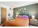 Cozy bedroom featuring an inviting bed, decorative shelves, and a vanity area, perfect for relaxation and personal style at 1811 S Quebec Way # 221, Denver, CO 80231