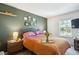 Serene bedroom with green accent wall, decorative gallery, and a cozy bed setting at 1811 S Quebec Way # 221, Denver, CO 80231