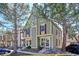 Charming townhome showcasing an inviting exterior with neutral siding and red shutters at 1811 S Quebec Way # 221, Denver, CO 80231