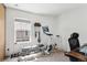 Bright home gym equipped with exercise bike, weights, and bench for a complete fitness routine at 1811 S Quebec Way # 221, Denver, CO 80231