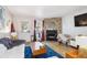 Inviting living area featuring a stone fireplace, hardwood floors, and ample natural light at 1811 S Quebec Way # 221, Denver, CO 80231