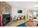 Cozy living room featuring a stone fireplace, hardwood floors, and contemporary furnishings at 1811 S Quebec Way # 221, Denver, CO 80231