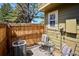 Cozy outdoor patio with seating, ambient string lights, and a view of the lush surroundings at 1811 S Quebec Way # 221, Denver, CO 80231