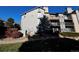 Exterior view of gray apartments includes balconies and green space at 2575 S Syracuse Way # M108, Denver, CO 80231