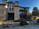 Charming condo building with stone facade, balconies, and mature landscaping offers a inviting curb appeal at 2575 S Syracuse Way # M108, Denver, CO 80231