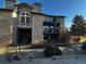 Charming condo building with stone facade, balconies, and mature landscaping offers a inviting curb appeal at 2575 S Syracuse Way # M108, Denver, CO 80231