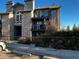 Charming condo building with stone facade, balconies, and mature landscaping offers a inviting curb appeal at 2575 S Syracuse Way # M108, Denver, CO 80231