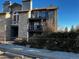 Charming condo building with stone facade, balconies, and mature landscaping offers a inviting curb appeal at 2575 S Syracuse Way # M108, Denver, CO 80231