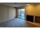 Bright living room with fireplace, plush carpet, and sliding doors to a private outdoor patio at 2575 S Syracuse Way # M108, Denver, CO 80231