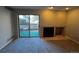 Bright living room with fireplace, plush carpet, and sliding doors to a private outdoor patio at 2575 S Syracuse Way # M108, Denver, CO 80231