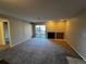 Bright living room with fireplace, plush carpet, and sliding doors to a private outdoor patio at 2575 S Syracuse Way # M108, Denver, CO 80231