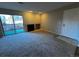 Bright living room with fireplace, plush carpet, and sliding doors to a private outdoor patio at 2575 S Syracuse Way # M108, Denver, CO 80231