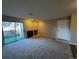 Bright living room with fireplace, plush carpet, and sliding doors to a private outdoor patio at 2575 S Syracuse Way # M108, Denver, CO 80231