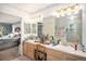 Spacious bathroom with double sinks, a soaking tub, and a view to another room at 5491 S Youngfield W Ct, Littleton, CO 80127