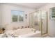 Relaxing bathroom featuring a large soaking tub and a separate glass shower at 5491 S Youngfield W Ct, Littleton, CO 80127