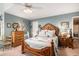 Elegant bedroom with a carved wood bed frame and matching dresser set at 5491 S Youngfield W Ct, Littleton, CO 80127