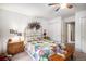Comfortable bedroom with a quilt, two side tables, and closet at 5491 S Youngfield W Ct, Littleton, CO 80127