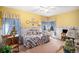 A bright and cheery bedroom with light yellow walls and blue accents at 5491 S Youngfield W Ct, Littleton, CO 80127