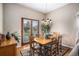 Inviting dining room featuring a wood table, chairs, and sliding glass doors at 5491 S Youngfield W Ct, Littleton, CO 80127