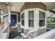 Spacious front porch offers seating and a view of the lush surroundings, creating a welcoming outdoor space at 5491 S Youngfield W Ct, Littleton, CO 80127
