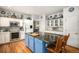 A spacious kitchen featuring an island, ample cabinet space, and modern appliances at 5491 S Youngfield W Ct, Littleton, CO 80127