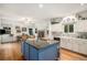 Bright, spacious kitchen with an island, fireplace, and classic white cabinets at 5491 S Youngfield W Ct, Littleton, CO 80127