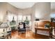 Bright living room featuring hardwood floors, large windows with views, and tasteful decor and furnishings at 5491 S Youngfield W Ct, Littleton, CO 80127