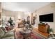 Open concept living room showcases hardwood floors, neutral walls, staircase and a smooth transition between living spaces at 5491 S Youngfield W Ct, Littleton, CO 80127