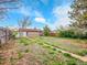A spacious backyard with lush greenery and a charming pathway, perfect for outdoor entertaining at 1746 S Alcott St, Denver, CO 80219