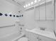 Bright bathroom featuring a tiled shower, vanity, and updated fixtures at 1746 S Alcott St, Denver, CO 80219