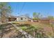 Spacious backyard with a mix of grass and dry areas, along with a shed and patio at 640 S Quivas St, Denver, CO 80223
