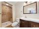Bathroom featuring tiled walk-in shower, vanity, and toilet at 640 S Quivas St, Denver, CO 80223