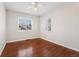 Bedroom featuring gleaming hardwood floors and bright, sunlit windows at 640 S Quivas St, Denver, CO 80223