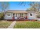 Charming home with a cozy front porch and well-maintained lawn on a sunny day at 640 S Quivas St, Denver, CO 80223