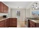 Traditional kitchen with cherry cabinets, granite countertops, and stainless steel stove at 640 S Quivas St, Denver, CO 80223