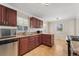 Traditional kitchen with cherry cabinets, granite countertops, and stainless steel appliances at 640 S Quivas St, Denver, CO 80223