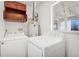 Bright laundry room with white washer, dryer, and storage at 640 S Quivas St, Denver, CO 80223
