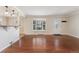 Spacious living room with gleaming hardwood floors, bay window, and great natural light at 640 S Quivas St, Denver, CO 80223