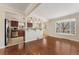 Bright and open living area leading to the kitchen, featuring hardwood floors at 640 S Quivas St, Denver, CO 80223