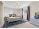 This staged bedroom is bright and spacious and features a blue area rug at 640 S Quivas St, Denver, CO 80223
