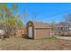 Backyard storage shed on a lot with a chain link fence at 640 S Quivas St, Denver, CO 80223