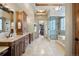 A spacious bathroom featuring a marble vanity, walk-in shower, and access to the closet at 1105 Northwood Ln, Castle Rock, CO 80108