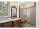 Bathroom featuring a vanity with granite counters and a glass-enclosed shower at 1105 Northwood Ln, Castle Rock, CO 80108
