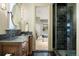 Bathroom with granite countertop vanity, and glass-enclosed tiled shower at 1105 Northwood Ln, Castle Rock, CO 80108
