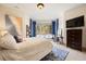 Bright bedroom with large windows, blue accents, and a comfortable bed at 1105 Northwood Ln, Castle Rock, CO 80108