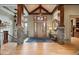 Grand foyer with hardwood floors, custom woodwork, stone accents, and stylish lighting creating a luxurious entrance at 1105 Northwood Ln, Castle Rock, CO 80108